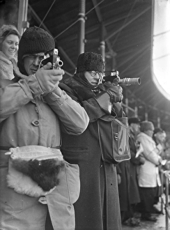 Amateur photographers film with narrow-film cameras during the bandy match at the Stockholm stadium between Sweden