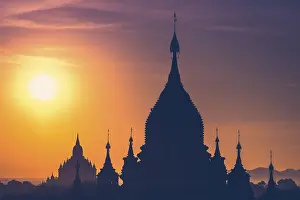 Amazing misty sunrise colors and silhouette of ancient Buddhist Temples at Bagan Kingdom