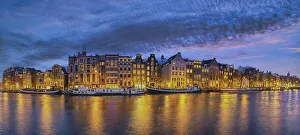 Amsterdam Netherlands, night panorama city skyline of Dutch house at canal waterfront