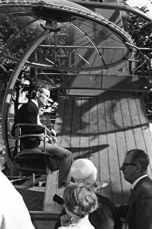 Amusement park in the 1960s. A couple is seen in one of the attractions that are offered on the grounds