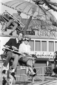 Amusement park in the 1960s. A couple is seen in one of the attractions that are offered on the grounds