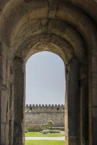 The ancient fortress wall is visible in the arch