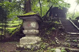 Ancient stone lantern structure in Japanese temple yard in Nikko