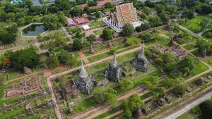 An ancient temple complex next to a city and a modern temple