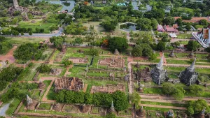 An ancient temple complex next to a city and a modern temple
