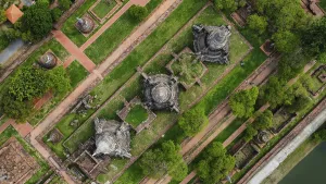 An ancient temple complex next to a city and a modern temple