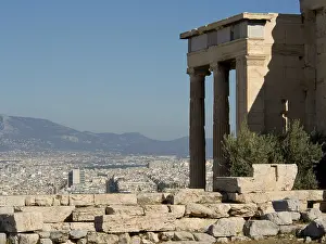 An ancient temple with a view of the modern city and surrounding mountains