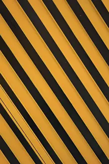 Angled yellow and black stripes on a steel door in Otavalo