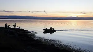 Angler on the beach during sunset