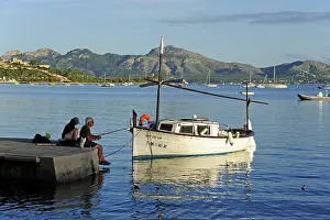 Angler with fishing boat in the bay of Puerto de Pollensa