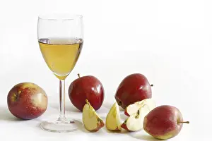 Apple juice in a glass, red apples