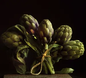 Five artichokes are artistically bundled with twine