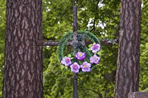 Artificial flower mix on a cross