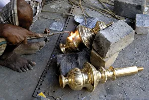 Artisan in the process of welding to make bronze oil lamp at NachiyarKoil Nachiyar Koil near Thanjavur Tanjore