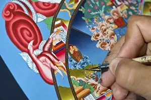Category Buddhism Prints: Artist painting a colourful Thangka in an art school