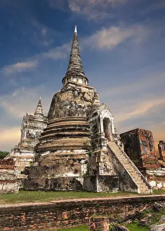 Asian religious architecture. Ancient Buddhist pagoda ruins at Wat Phra Sri Sanphet temple under sunset sky