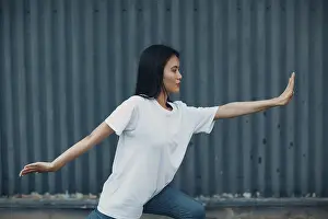 Asian young woman doing qigong exercise summer outdoor