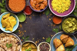 Assorted indian food on dark wooden background