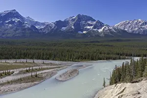 Athabasca River with glacial meltwater carrying rock flour in front of the Rocky Mountains