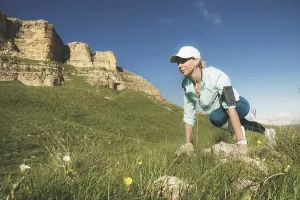 Athletic woman was ready to run at the foot of the rocks