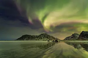 Aurora over the mountains and sea of Lofoten