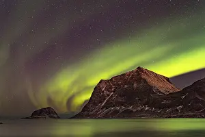 Aurora over the mountains and sea of Lofoten