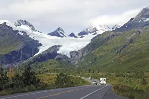 Autumn landscape, car driving towards a glacier calving deep into the valley