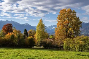 Autumn scenic with the view from the town Murnau to the alps