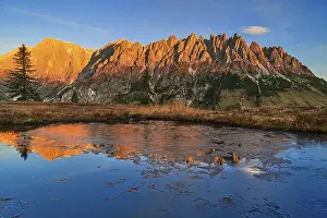 Autumnal alpine pasture at sunrise