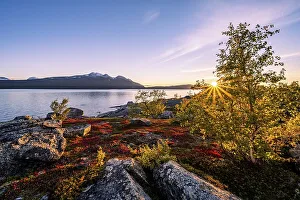 Autumnal fell landscape with lake Akkajaure and mountain range Akka