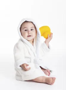 Baby in a bathrobe go to a bath with yellow duck