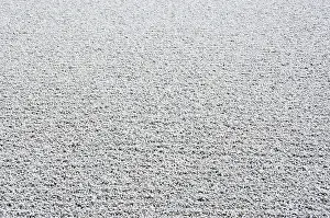 Background of gravel arranged in lines in a stone garden of a zen buddhist temple