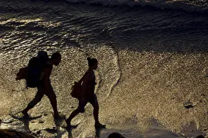 October 2019 Prints: Two backpackers walking along the beach