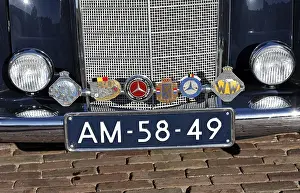 Badges of several automobile clubs on the bumper of a Mercedes