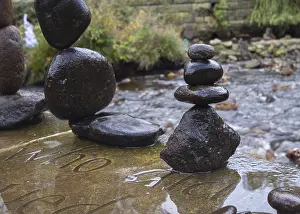 Balanced stones stack next to a stream