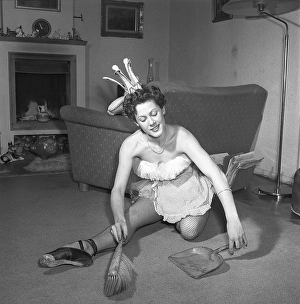 Ballerina in the 1950s. A young ballerina all dressed up in her costume and shoes is cleaning the floor with a brush and a dustpan. Their names are Kerstin Bratt Deckner and John-Ivar Deckner, theatre dancers and actors
