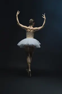 A ballet dancer performs gracefully in a white tutu