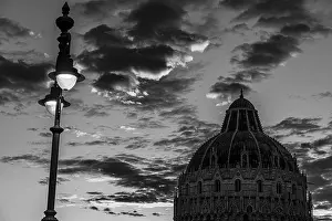 Baptistery under a street lamp at sunset