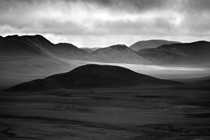 Barren, mountainous landscape with light and shades
