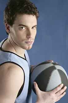Basket player young man over blue grunge background