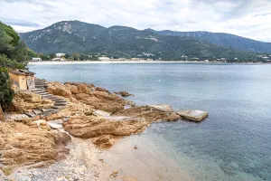 Bathing hut on the rugged red rocky coast