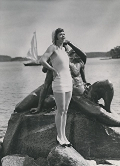 On the beach in the 1930s. A young woman wearing a swimsuit bathing wear of this era