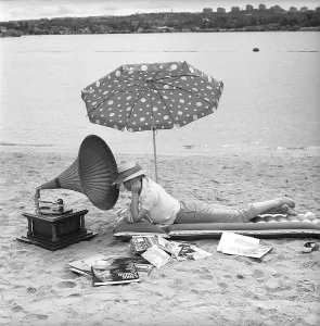 On the beach 1960. A young woman on a beach