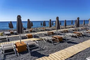 Beach, empty, organised, with sun loungers and parasols