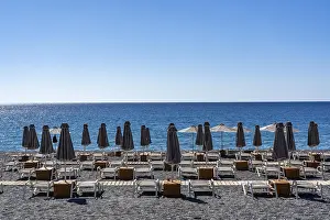 Beach, empty, organised, with sun loungers and parasols