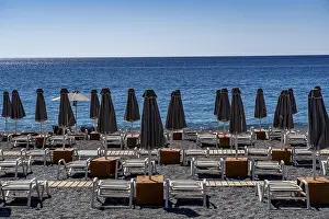 Beach, empty, organised, with sun loungers and parasols