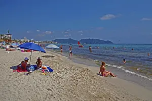 Beach holidaymakers sunbathing