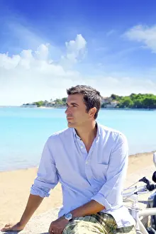 Beach vacation man looking the sea blue shirt bicycle
