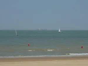 Beach view with two sailing boats
