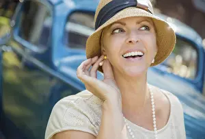 Beautiful 1920s dressed girl near vintage car outdoors portrait